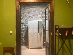 a door leading into a room with lockers in it at Titan House in İzmir