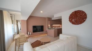 a living room with a white couch and a television at Bono Residence in Marmaris