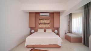 a bedroom with a large bed and a window at Bono Residence in Marmaris