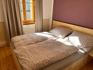 a bed in a bedroom with two pillows on it at Haus Sonnenblick in Düns