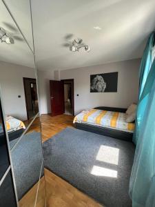 a bedroom with a bed and a glass wall at Chaika Sea Apartment in Varna City