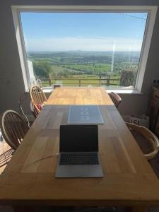 a laptop computer sitting on top of a wooden table at Glenogue Farm in Gorey