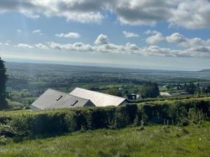 a house on top of a hill with a view at Glenogue Farm in Gorey