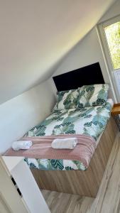 - un lit avec 2 serviettes dans une chambre dans l'établissement Domki pod gwieździstym niebem, à Zastań
