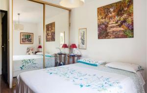 a bedroom with two beds and a painting on the wall at Amazing Apartment In Marseille With Kitchen in Marseille