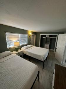 a hotel room with two beds and a window at Breezy Palms Resort in Islamorada