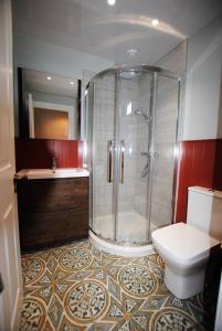 a bathroom with a shower and a toilet at Auld Fishers Hoist- traditional home by the sea in Anstruther