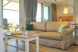 a living room with a couch and a table at Appartements "Zum Leuchtturm" Hafen Rankwitz Insel Usedom in Rankwitz