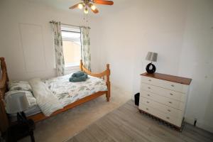 1 dormitorio con 1 cama, vestidor y ventana en Whitley Bay - Sleeps 6 - Refurbished Throughout - Fast Wifi - Dogs Welcome, en Whitley Bay
