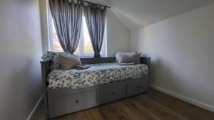 a bed in a room with a window at Villa Saulkrasti Balta Kapa White Dunes in Saulkrasti