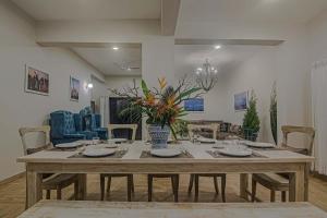 a large wooden table in a living room at StayVista at Mawi Summers in Arambol