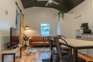 a living room with a table and a couch at Campfire Cottage Fireplace, fire pit & no chores! in Kingston