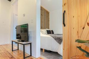 a bedroom with a bed and a television on a table at Campfire Cottage Fireplace, fire pit & no chores! in Kingston