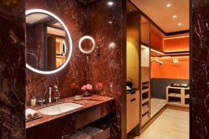 a bathroom with a sink and a mirror at Bulgari Hotel Roma in Rome