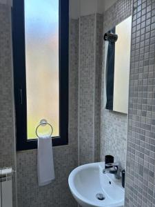 都靈的住宿－ALLOGGIO ALBA，一间带水槽和窗户的浴室