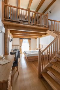 a bedroom with a staircase and a bed in a room at Hotel Rifugio Solander in Commezzadura