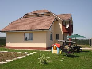 a small house with a table and a playground at Vila Antonia in Eforie Nord