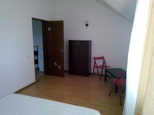 a room with a door and a table and a chair at Vila Antonia in Eforie Nord