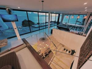 a glass floor in a house with a view of the ocean at Villa Valentin in Salad Beach