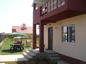 a house with a patio with a table and an umbrella at Vila Antonia in Eforie Nord +11 photos