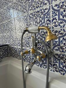 a bathroom with a faucet and a shower at Le Temps d'un Rêve in Ravenel