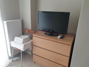 a television sitting on top of a dresser at Κεντρικό στούντιο 250m σχεδόν από την παράλια. in Volos