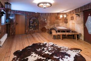 a room with a table and a wooden floor at Chalet Magdalena in Avelengo