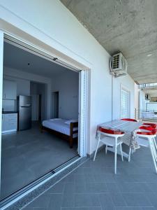 a bedroom with a table and a bed in a room at Vila Jona Palasë in Dhërmi