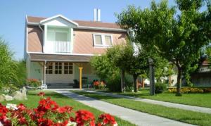 a house with red flowers in front of it at U Mami in Veľký Meder