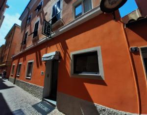 a orange building with a window on a street at HOTEL MALIBU in Spotorno