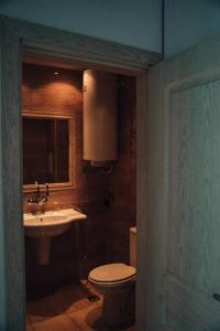 a bathroom with a toilet and a sink at Lovely apartment near Kavatsi in Sozopol