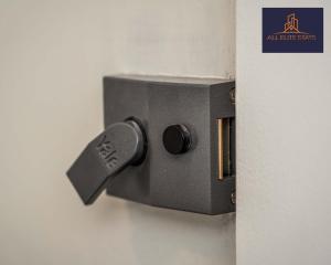 a metal door lock on a white wall at Swan House Apartment 2 - 1 Bed Apartment - Sleeps up to 4 - Free Parking - Liverpool - close to city centre - By ALL ELITE STAYS in Liverpool