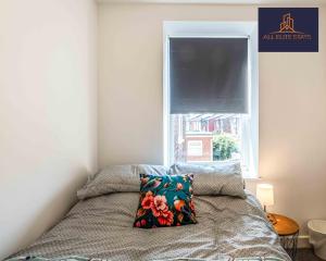 a bedroom with a bed with a pillow and a window at Swan House Apartment 2 - 1 Bed Apartment - Sleeps up to 4 - Free Parking - Liverpool - close to city centre - By ALL ELITE STAYS in Liverpool
