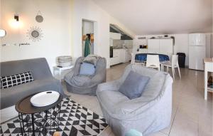 馬藏的住宿－Gorgeous Home In Mazan With Outdoor Swimming Pool，一间带两把椅子和一张桌子的客厅以及一间厨房