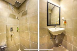 a bathroom with a sink and a mirror at FabHotel Heera Holiday Inn in Kolkata