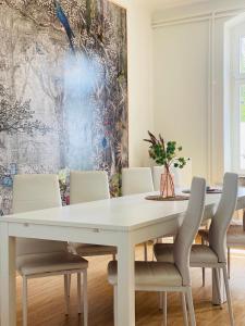 a dining room with a white table and chairs at Studio mit Küche in Pirna