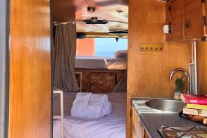 a small kitchen with a bed and a sink at Ericeira Destination in Ericeira