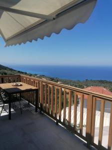 a balcony with a table and a view of the ocean at Sun Meets Sea in Athanion