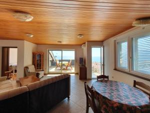 a living room with a couch and a table at Apartmani Miljak Omiš in Omiš