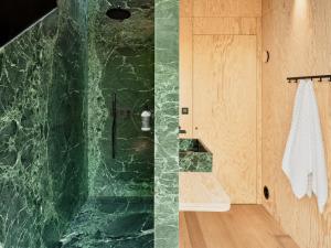 a bathroom with a shower with green marble walls at Hutstuf The Eagle & Private Outdoor Spa in La-Roche-en-Ardenne