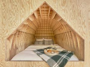a igloo bed with a plate of food on it at Hutstuf The Eagle & Private Outdoor Spa in La-Roche-en-Ardenne
