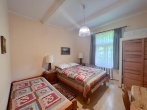 a bedroom with a bed and a dresser and a window at Wynajem Pokoi-Dom Sw Stanislawa in Zakopane