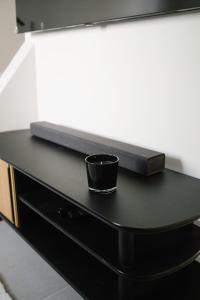 a black desk with a cup on top of it at Aldoar House in Porto