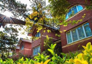 a red brick building with the sun in the sky at Carilo Hills by bund in Carilo