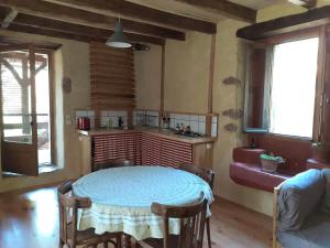 a kitchen with a table and chairs in a room at La maison parfumée in La Valade