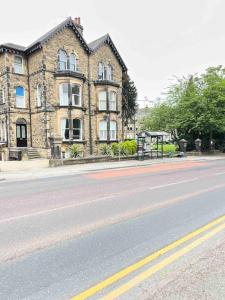 an empty street in front of a large building at 2 Bed ground floor apartment, sleeps 4 with free parking in Harrogate