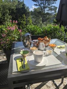 a glass table with a tray of food on it at Le Clos sous le chemin in Seillans +6 photos