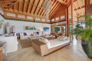 a living room with a couch and a table at Luxurious 8-BR Villa with Ocean View, Jacuzzi, Home Cinema and Resort Access in Casa de Campo in La Romana