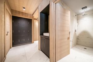 a bathroom with black cabinets and a walk in shower at Apartment Kanoko Les Gets- BY EMERALD STAY in Les Gets +33 photos