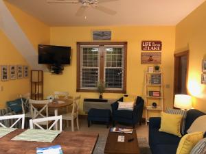 a living room with a couch and a table at Lakeside Suites in Elkhart Lake